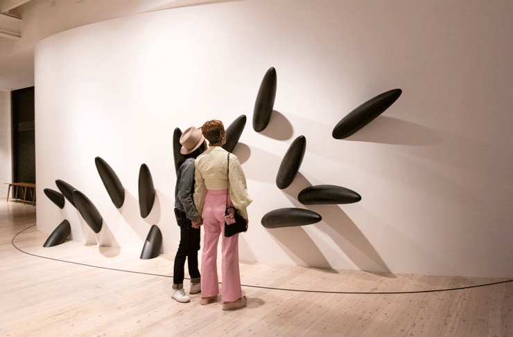 Couple looking at art on wall